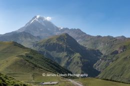 Peak of Mount Kazbek in the Caucasus Mountains, seen from Gerbeti Trinity Church in Kazbegi, Georgia