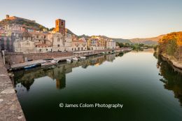 Reflection of the houses along Via Santa Giusta on the River Temo, Bosa, Sardinia