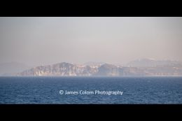 Hazy view of Fira, Santorni, Greece from boat in the Caldera