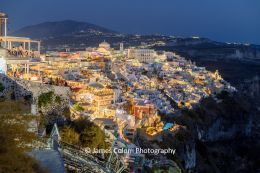 View of multi-coloured lights of Fira, Santorini, Greece at night