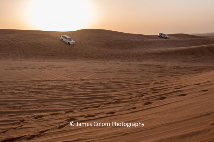 Sun setting during desert safari on the sand dunes outside Dubai, UAE